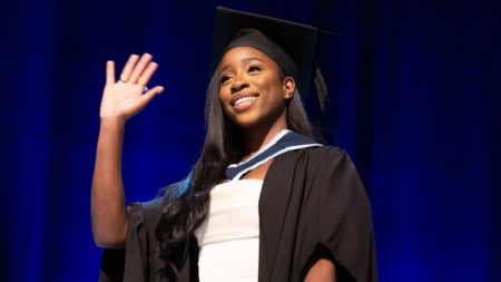 NCI Graduate waving